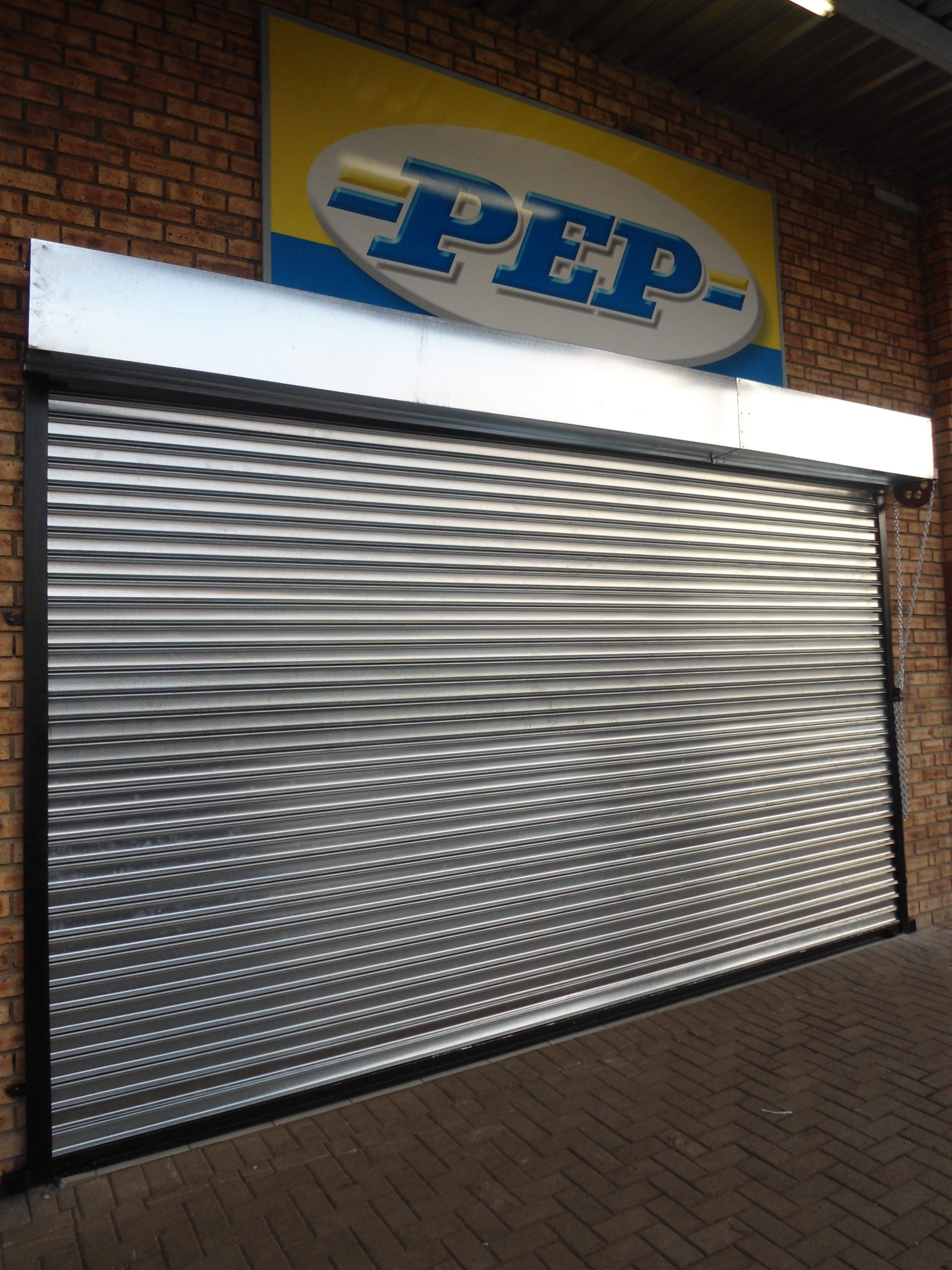 Repaired roller shutter door at a business, showcasing Empire Doors' professional and reliable commercial repair services.